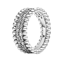 Load image into Gallery viewer, Silver ring with a textured band and clear gemstones on a white background