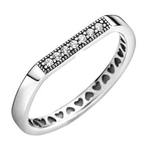 Load image into Gallery viewer, Silver ring with heart patterns and embedded stones on a white background
