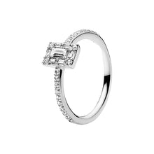 Load image into Gallery viewer, Silver ring with emerald-cut diamond and smaller diamonds on a white background