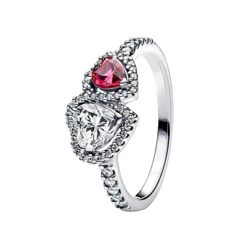 Silver ring with a red gemstone and clear diamond on a white background