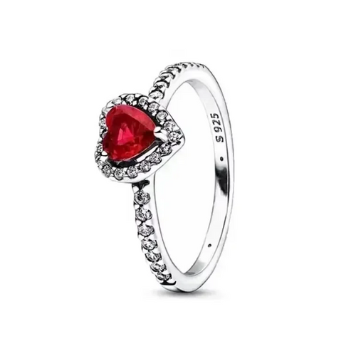 Silver ring with a heart-shaped red gemstone on a white background