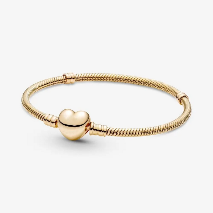 Gold bracelet with a heart-shaped clasp on a white background